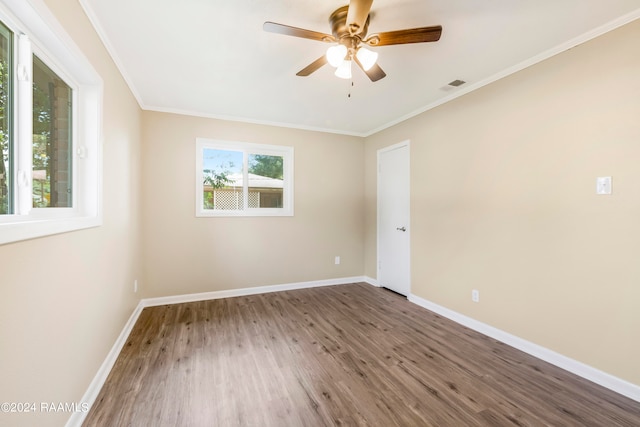 spare room featuring crown molding, hardwood / wood-style floors, and ceiling fan