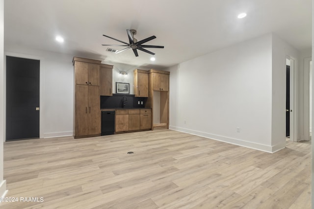 unfurnished living room with sink, ceiling fan, and light hardwood / wood-style flooring