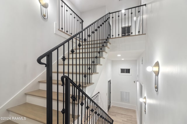 stairs featuring hardwood / wood-style floors