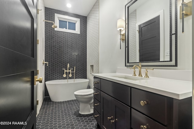 bathroom with toilet, vanity, a washtub, and tile patterned flooring