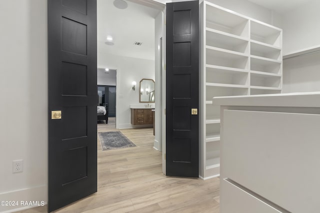 walk in closet featuring light wood-type flooring