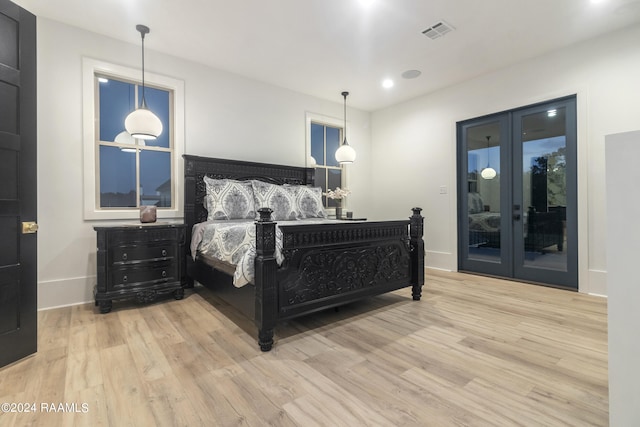 bedroom featuring access to exterior and light hardwood / wood-style floors