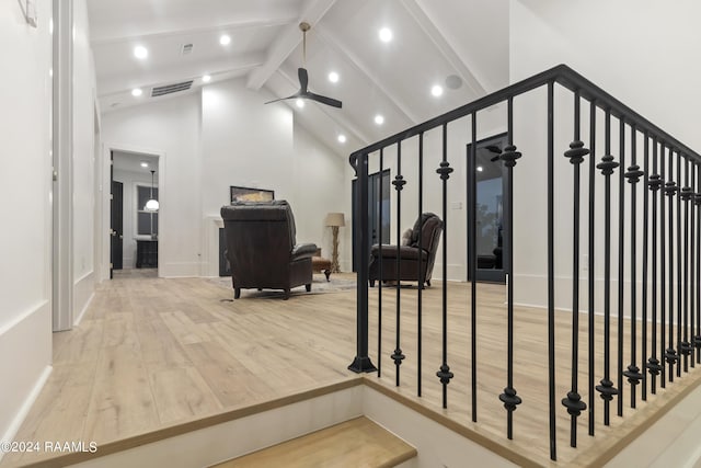 staircase featuring high vaulted ceiling, wood-type flooring, beam ceiling, and ceiling fan