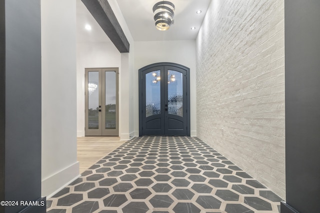 entrance foyer featuring french doors and hardwood / wood-style flooring