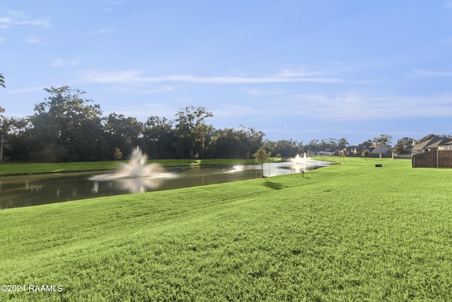 exterior space featuring a water view and a yard