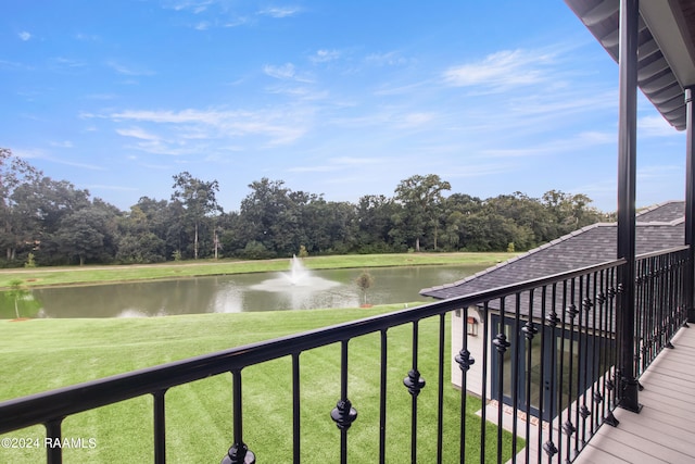 deck with a lawn and a water view