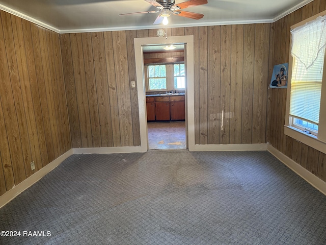 1010 W Simcoe St, Lafayette, LA 70501 - carpeted empty room featuring a ceiling fan and wooden walls