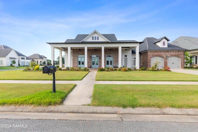 view of front of property featuring a garage, covered porch, and a front yard