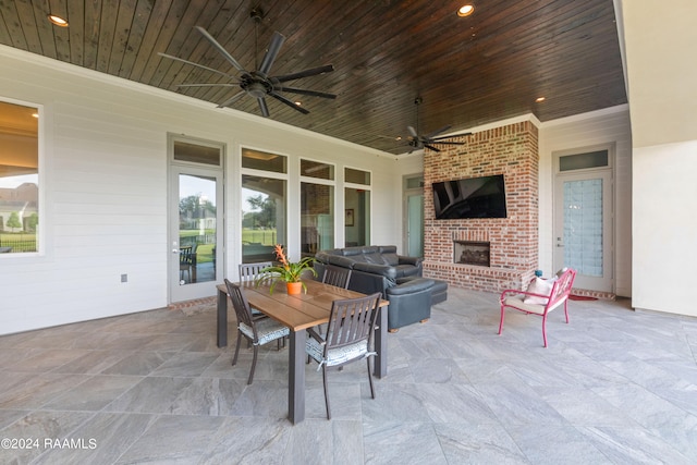 view of patio featuring ceiling fan and a fireplace