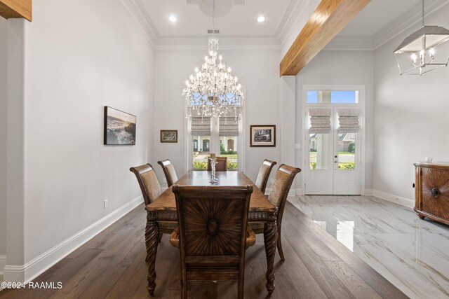 dining space featuring wood-type flooring, a chandelier, and ornamental molding