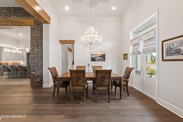 dining room featuring crown molding, dark hardwood / wood-style flooring, and a chandelier