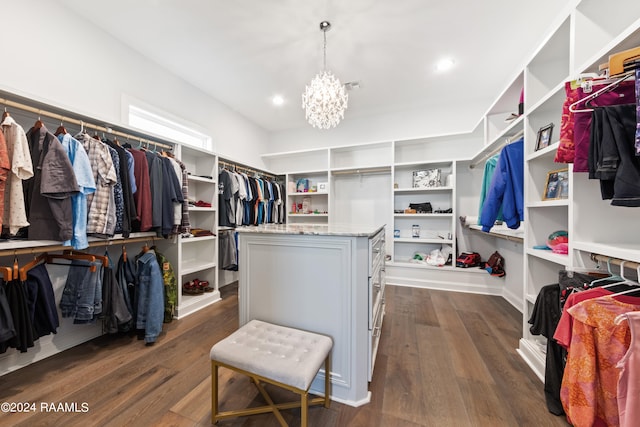 spacious closet featuring a notable chandelier and dark hardwood / wood-style floors