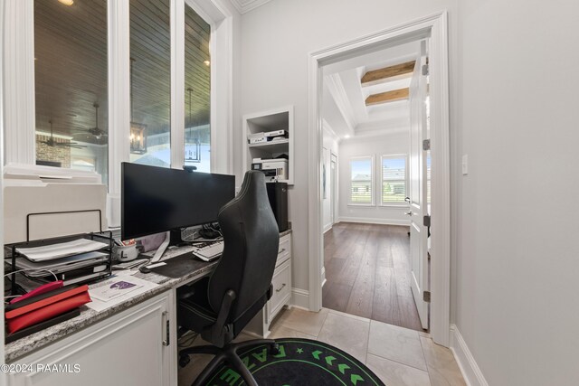 home office with coffered ceiling, beam ceiling, and light hardwood / wood-style floors