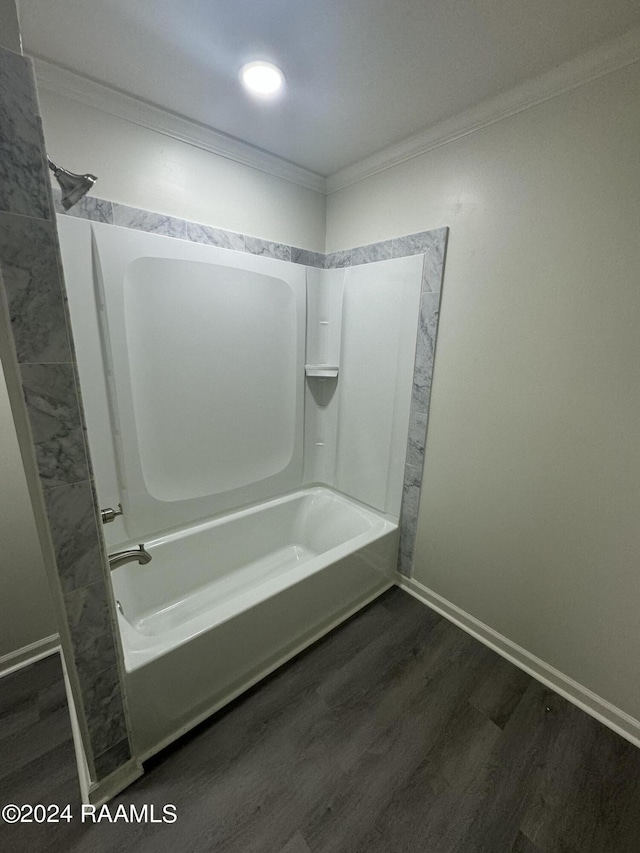 bathroom with hardwood / wood-style flooring, ornamental molding, and shower / bathtub combination