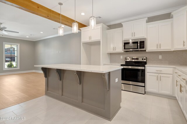 kitchen featuring ceiling fan, white cabinetry, pendant lighting, light tile patterned floors, and stainless steel appliances