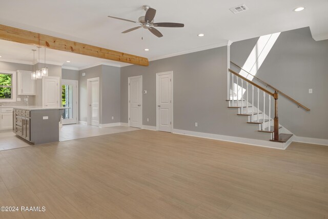 unfurnished living room with ceiling fan with notable chandelier, light hardwood / wood-style flooring, beam ceiling, a skylight, and ornamental molding