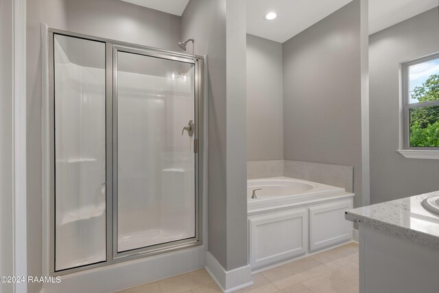 bathroom with tile patterned floors, vanity, and separate shower and tub