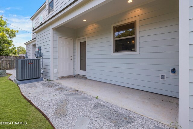 property entrance with central AC and a patio