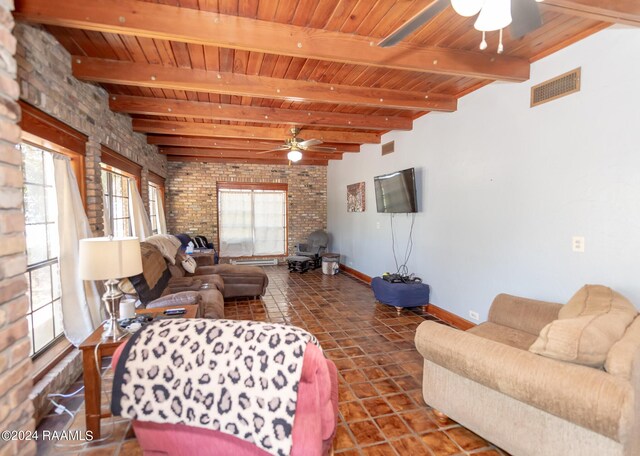 living room featuring ceiling fan, beam ceiling, wooden ceiling, and tile patterned flooring