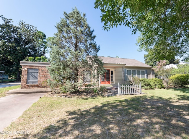 single story home featuring a front lawn