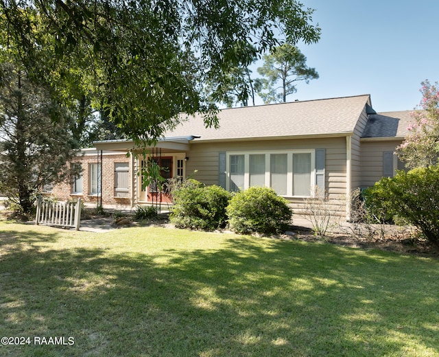 ranch-style home with a front lawn