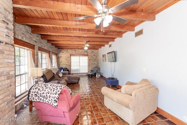 living room with tile patterned floors, beamed ceiling, wooden ceiling, and ceiling fan