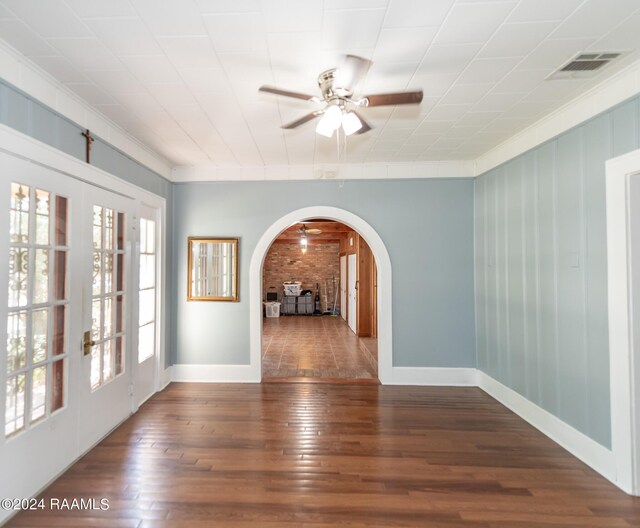 empty room with ceiling fan, dark hardwood / wood-style floors, and french doors