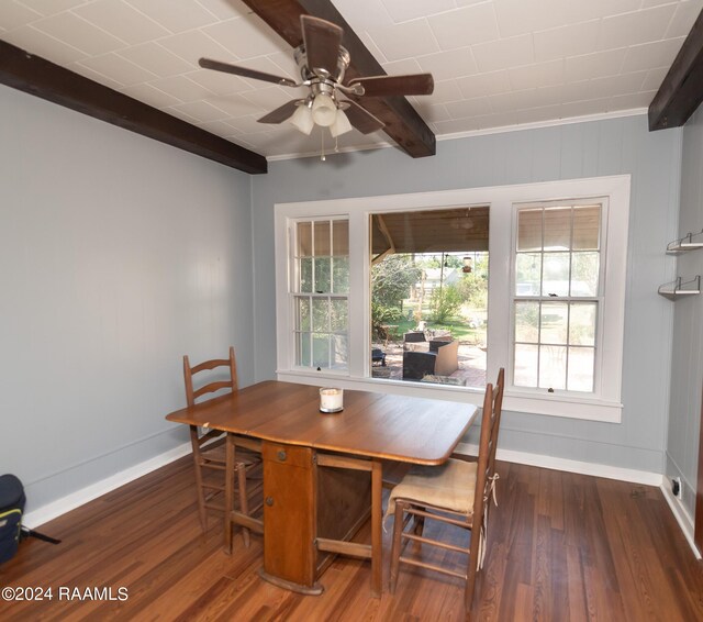 dining space featuring ceiling fan, dark hardwood / wood-style floors, ornamental molding, and beam ceiling