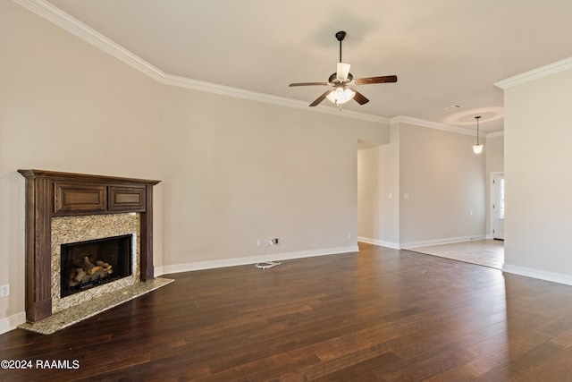 unfurnished living room featuring ceiling fan, a fireplace, hardwood / wood-style floors, and ornamental molding