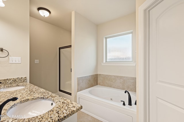 bathroom featuring tile patterned flooring, double vanity, and plus walk in shower