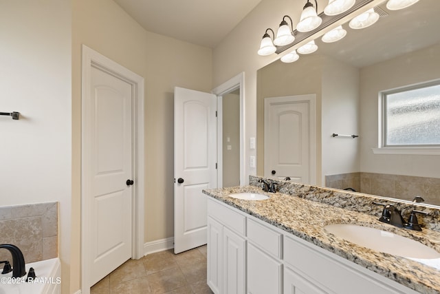 bathroom featuring a washtub, double vanity, and tile patterned flooring