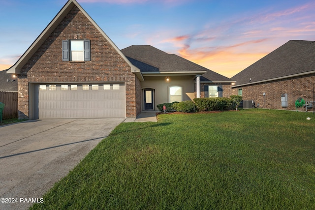 front of property with a lawn and central AC unit