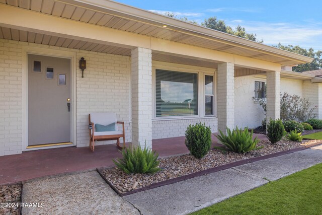 doorway to property featuring a porch