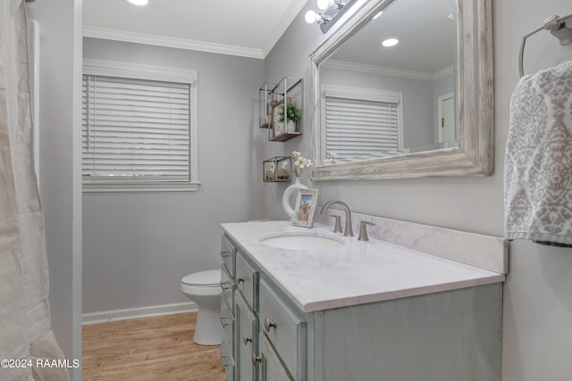 bathroom featuring vanity, hardwood / wood-style flooring, toilet, and ornamental molding