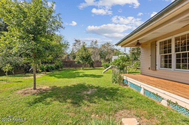 view of yard with a playground and a wooden deck