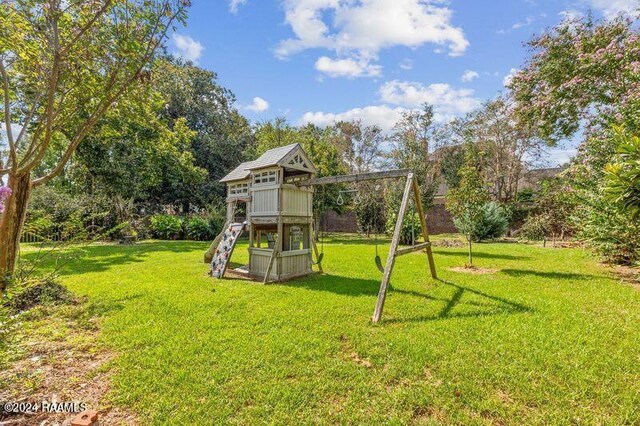 view of play area with a lawn and an outdoor structure