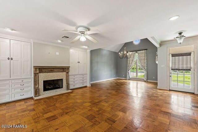 unfurnished living room featuring ceiling fan with notable chandelier, parquet flooring, ornamental molding, and a tile fireplace