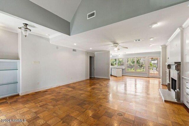 unfurnished living room with ornamental molding, vaulted ceiling, and ceiling fan