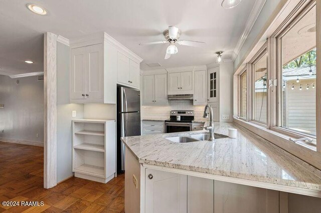 kitchen featuring kitchen peninsula, white cabinetry, ceiling fan, and stainless steel appliances