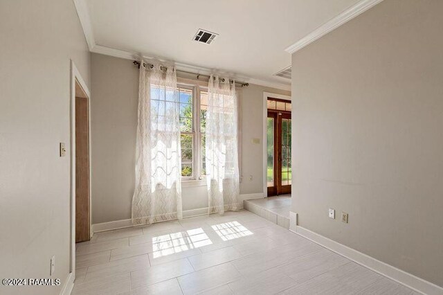 empty room featuring ornamental molding