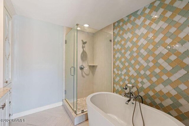 bathroom with tile patterned floors, vanity, and separate shower and tub