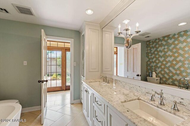 bathroom with vanity, toilet, a washtub, and tile patterned floors