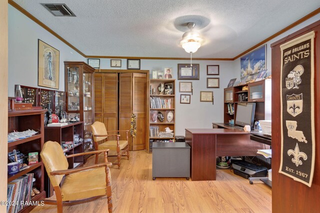 office with ceiling fan, light hardwood / wood-style floors, crown molding, and a textured ceiling