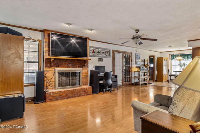 living room featuring crown molding, a wealth of natural light, and ceiling fan