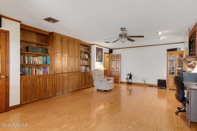 unfurnished office with ceiling fan, ornamental molding, and light hardwood / wood-style flooring