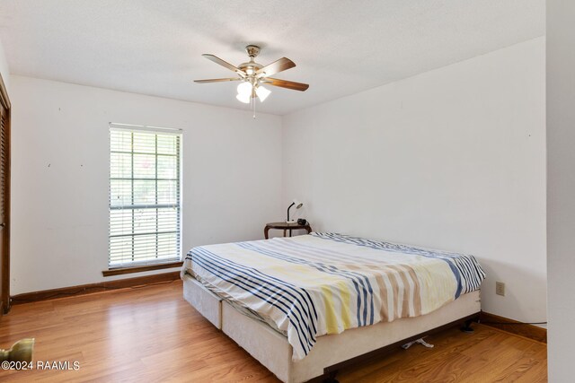 bedroom featuring ceiling fan and light hardwood / wood-style floors