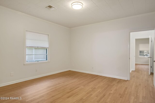 spare room with light hardwood / wood-style flooring and ornamental molding