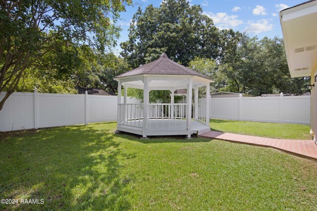 view of yard with a wooden deck and a gazebo