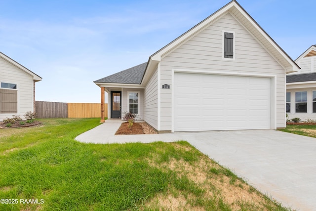 view of front of home featuring concrete driveway, roof with shingles, a front yard, a garage, and fence