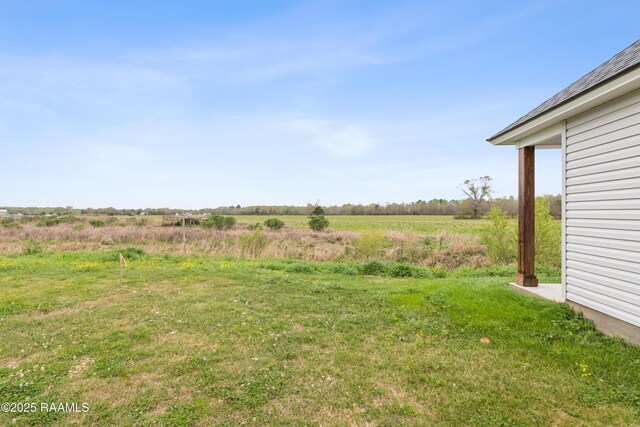 view of yard with a rural view